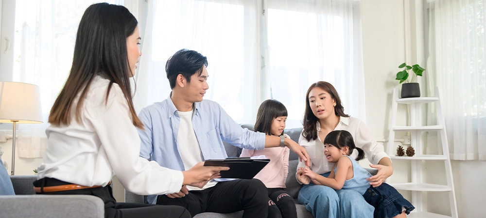 Family meeting with female insurance consultant offering promotions